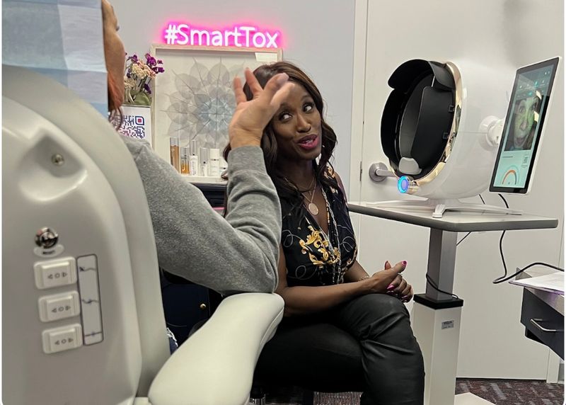 Dr. Kerline Marcelin in conversation with a patient during a consultation at Hudson Aesthetics MD